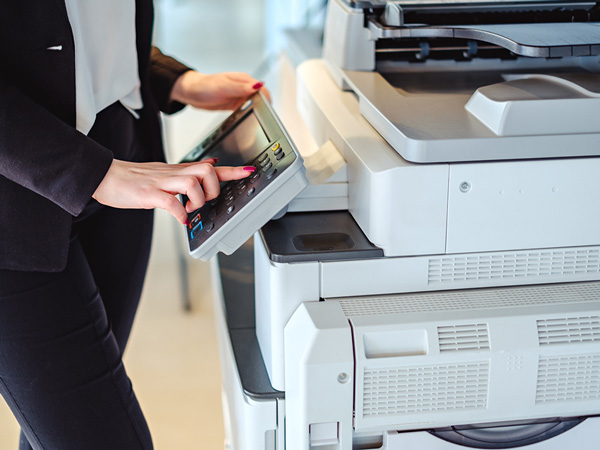 Woman using professional printer